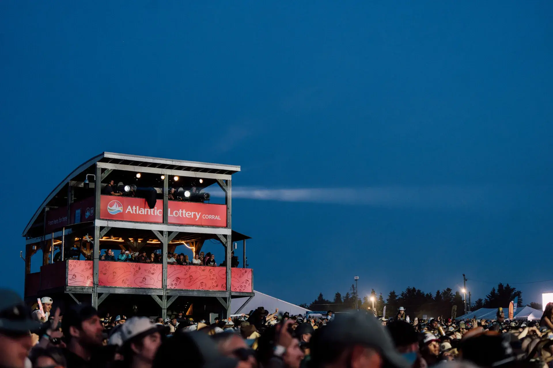 The Atlantic Lottery Corral at an outdoor concert at dusk, with a crowd below